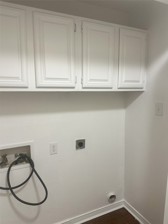 12921 Abrams Rd Unit 407, Dallas, TX 75243 - laundry room with cabinet space, washer hookup, electric dryer hookup, baseboards, and dark wood-style flooring