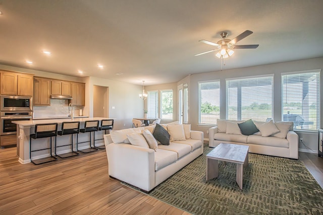 146 Chester Rd, Springtown, TX 76082 - living room with light wood-type flooring, ceiling fan, a chandelier, baseboards, and recessed lighting
