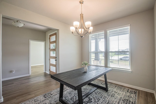 146 Chester Rd, Springtown, TX 76082 - dining space with baseboards, a chandelier, and wood finished floors
