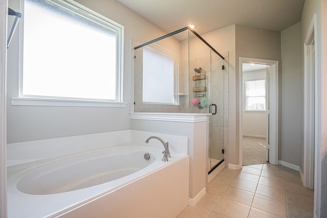 146 Chester Rd, Springtown, TX 76082 - bathroom with a bath, a stall shower, tile patterned flooring, and baseboards