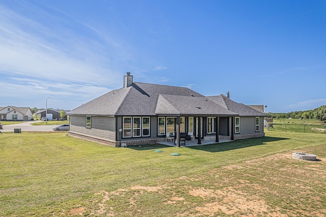 146 Chester Rd, Springtown, TX 76082 - back of house with a fire pit, a patio area, a shingled roof, and a chimney