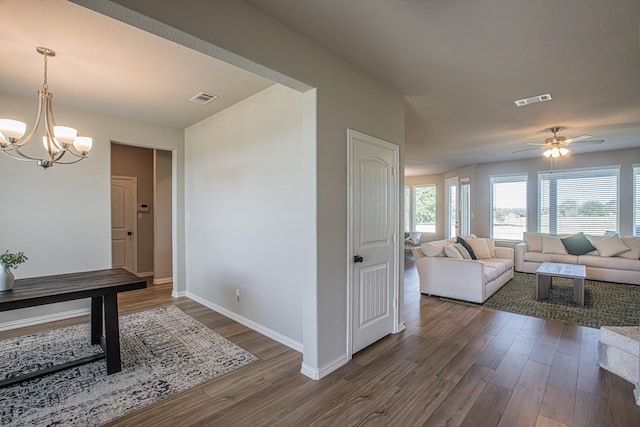 146 Chester Rd, Springtown, TX 76082 - hall featuring wood finished floors, a chandelier, healthy amount of natural light, and baseboards