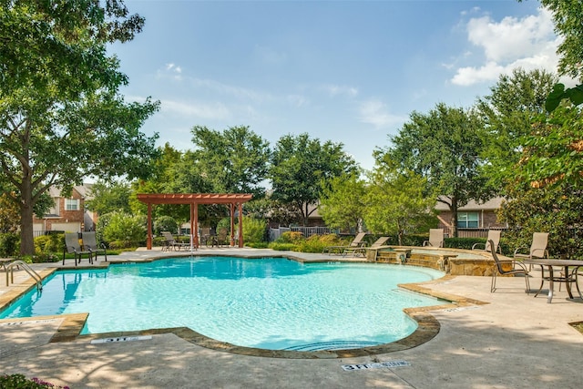 community pool featuring a pergola, a patio, fence, and a hot tub
