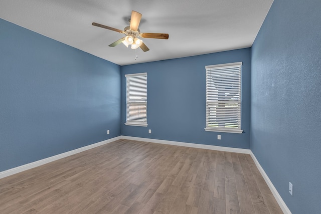 516 Smart Strike Trl, Granbury, TX 76049 - spare room featuring ceiling fan, wood finished floors, baseboards, and a textured wall
