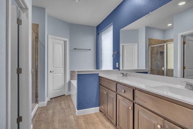516 Smart Strike Trl, Granbury, TX 76049 - full bath featuring a shower stall, wood finished floors, double vanity, a garden tub, and baseboards