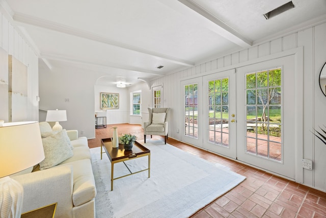 7609 Spring Valley Rd, Dallas, TX 75254 - living area with beam ceiling, brick floors, arched walkways, and french doors