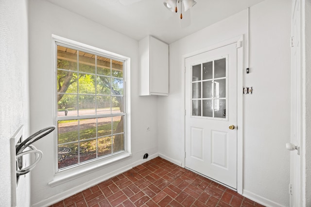 7609 Spring Valley Rd, Dallas, TX 75254 - doorway to outside featuring brick patterned flooring, a ceiling fan, and baseboards