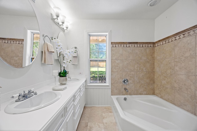 7609 Spring Valley Rd, Dallas, TX 75254 - bathroom featuring a bathtub, a wainscoted wall, and double vanity