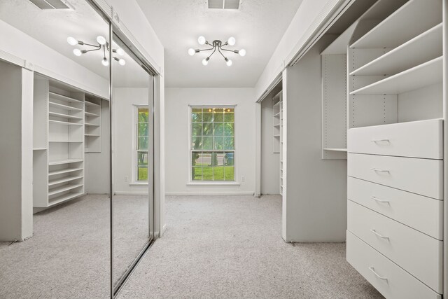 7609 Spring Valley Rd, Dallas, TX 75254 - walk in closet with a chandelier and carpet floors