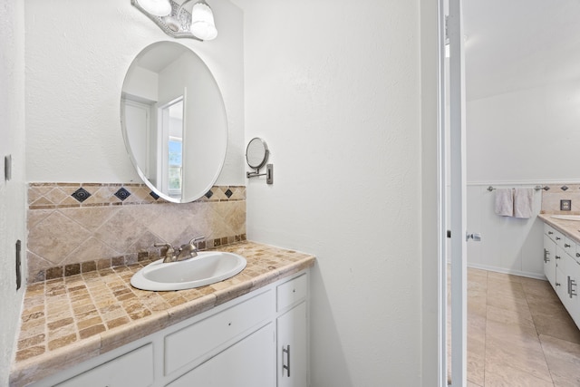 7609 Spring Valley Rd, Dallas, TX 75254 - bathroom featuring vanity, decorative backsplash, and tile patterned floors