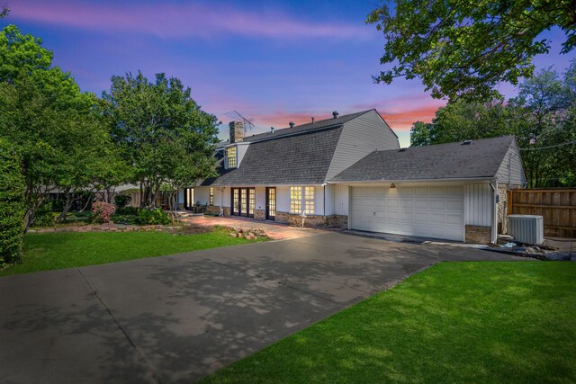 7609 Spring Valley Rd, Dallas, TX 75254 - dutch colonial featuring cooling unit, concrete driveway, a garage, a shingled roof, and a gambrel roof