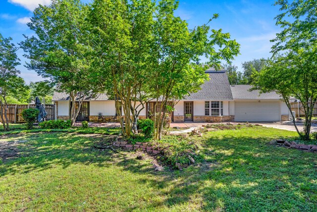 7609 Spring Valley Rd, Dallas, TX 75254 - view of front facade with a garage, brick siding, driveway, and a shingled roof