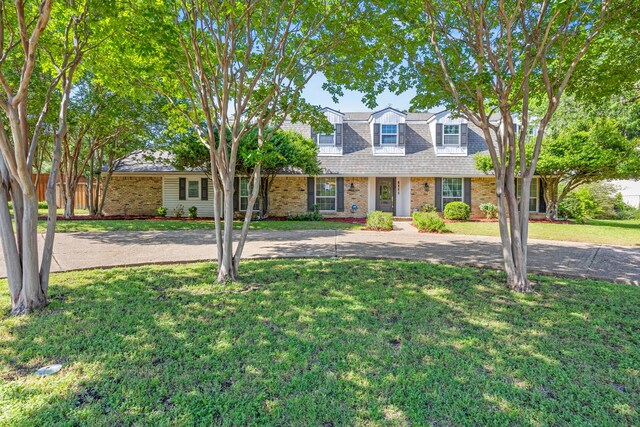 7609 Spring Valley Rd, Dallas, TX 75254 - view of front facade with brick siding and a front lawn