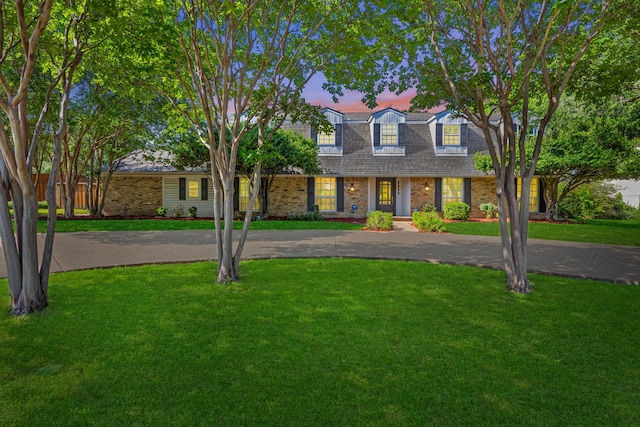 7609 Spring Valley Rd, Dallas, TX 75254 - view of front facade featuring brick siding, curved driveway, and a porch