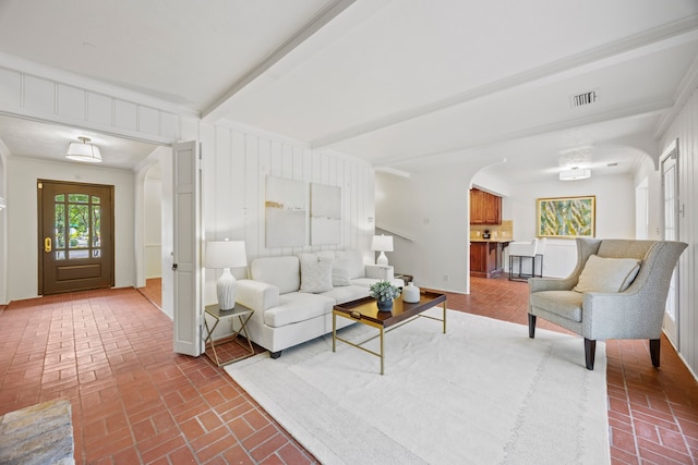7609 Spring Valley Rd, Dallas, TX 75254 - living area featuring arched walkways, brick flooring, and beam ceiling