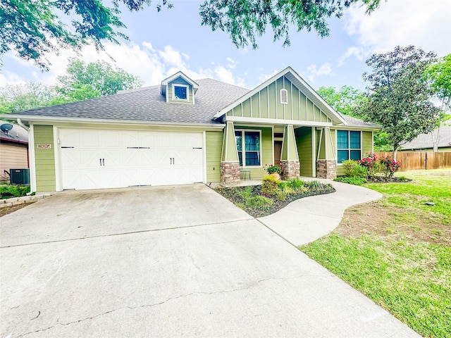517 N 2nd St, Midlothian, TX 76065 - craftsman-style house with fence, board and batten siding, a garage, concrete driveway, and central air condition unit