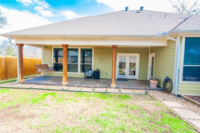 517 N 2nd St, Midlothian, TX 76065 - back of house with fence, a shingled roof, a patio, and french doors