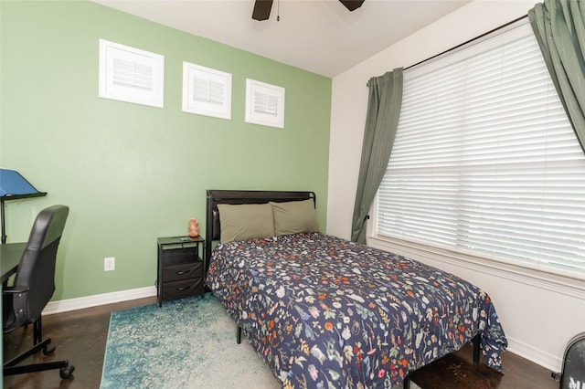 517 N 2nd St, Midlothian, TX 76065 - bedroom featuring baseboards, a ceiling fan, concrete floors, and multiple windows
