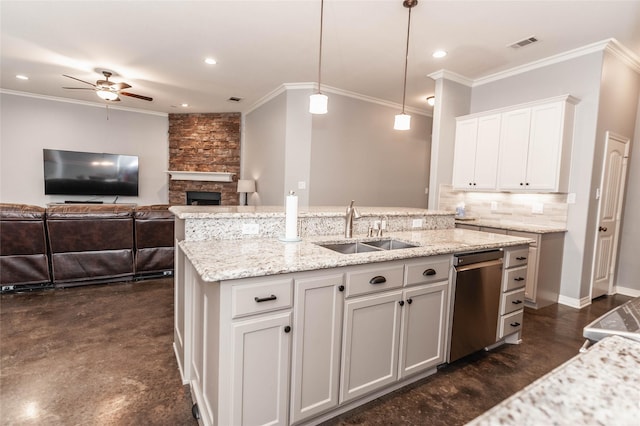 517 N 2nd St, Midlothian, TX 76065 - kitchen featuring a sink, a ceiling fan, an island with sink, tasteful backsplash, and a stone fireplace