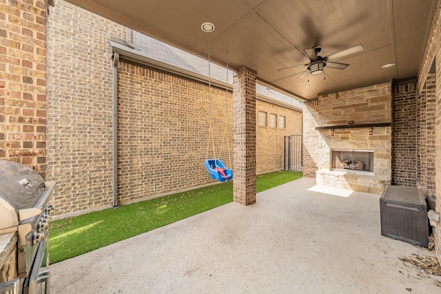670 Bridge St, Coppell, TX 75019 - view of patio / terrace with an outdoor stone fireplace, a ceiling fan, and a grill