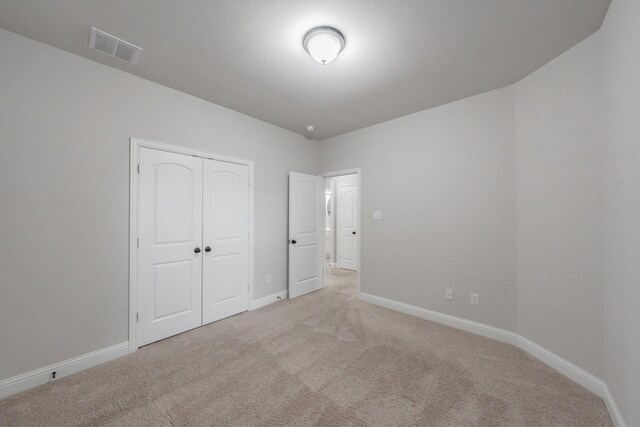 670 Bridge St, Coppell, TX 75019 - unfurnished bedroom featuring carpet, baseboards, and a closet