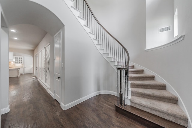 670 Bridge St, Coppell, TX 75019 - stairs with wood finished floors, arched walkways, baseboards, and recessed lighting