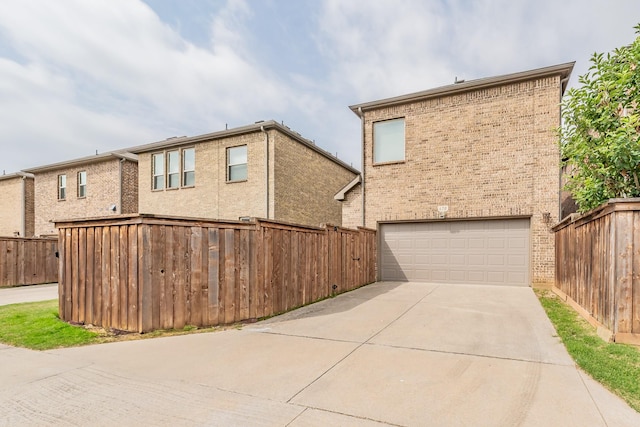 670 Bridge St, Coppell, TX 75019 - rear view of house featuring a garage, driveway, and brick siding