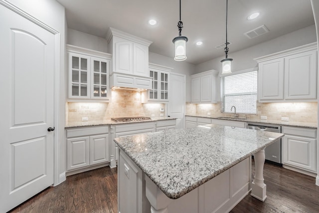 670 Bridge St, Coppell, TX 75019 - kitchen featuring appliances with stainless steel finishes, white cabinetry, a sink, a kitchen island, and glass insert cabinets