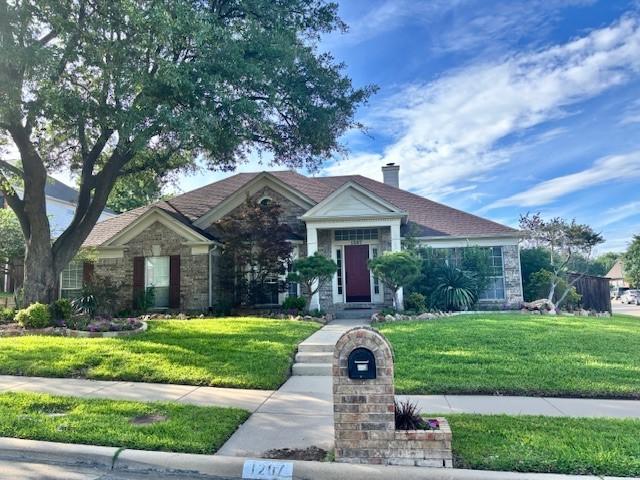 1207 Brittainy Dr, Carrollton, TX 75006 - ranch-style house featuring a front lawn, stone siding, and a chimney
