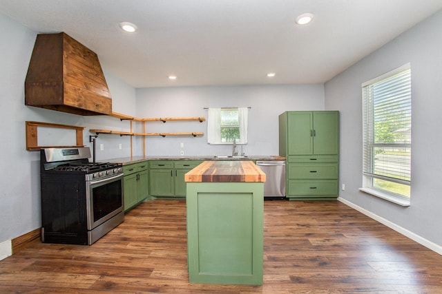 301 Sycamore St, Bardwell, TX 75101 - kitchen featuring green cabinets, butcher block counters, stainless steel appliances, a kitchen island, and dark wood finished floors