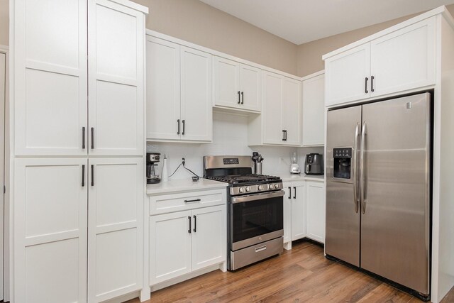 3105 Kensington Dr, Mesquite, TX 75150 - kitchen featuring appliances with stainless steel finishes, light countertops, white cabinetry, and light wood-style flooring
