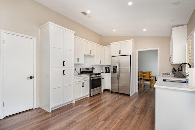 3105 Kensington Dr, Mesquite, TX 75150 - kitchen with appliances with stainless steel finishes, a sink, wood finished floors, white cabinetry, and recessed lighting