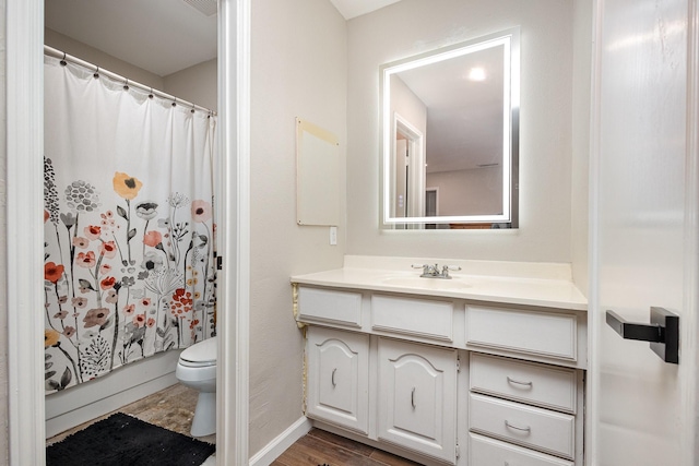 3105 Kensington Dr, Mesquite, TX 75150 - full bathroom with toilet, wood finished floors, vanity, a shower with curtain, and baseboards