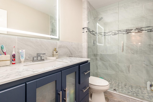 3105 Kensington Dr, Mesquite, TX 75150 - full bathroom with a stall shower, vanity, tile walls, and toilet