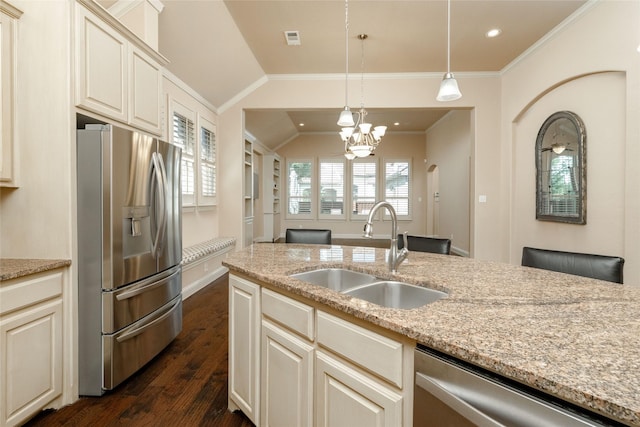 3900 Plum Vista Pl, Arlington, TX 76005 - kitchen with stainless steel appliances, a sink, dark wood-style floors, light stone countertops, and hanging light fixtures