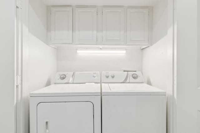 7525 Holly Hill Dr Unit 17, Dallas, TX 75231 - washroom featuring washing machine and clothes dryer and cabinet space