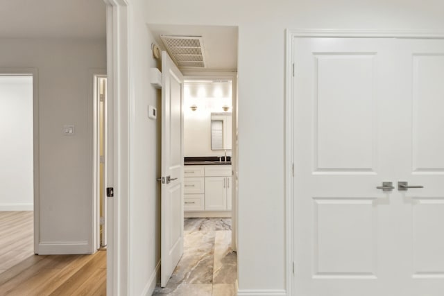 7525 Holly Hill Dr Unit 17, Dallas, TX 75231 - hall with baseboards and light wood finished floors