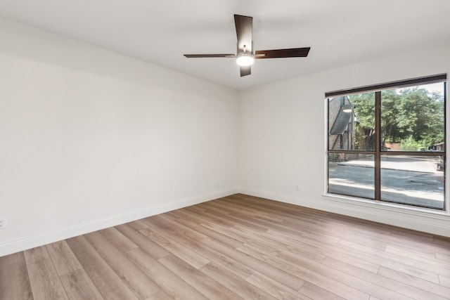 7525 Holly Hill Dr Unit 17, Dallas, TX 75231 - empty room featuring light wood-style flooring, baseboards, and ceiling fan