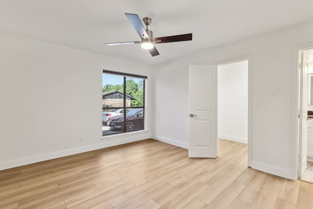 7525 Holly Hill Dr Unit 17, Dallas, TX 75231 - spare room with light wood-style floors, ceiling fan, and baseboards