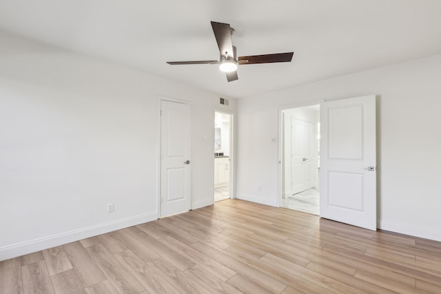 7525 Holly Hill Dr Unit 17, Dallas, TX 75231 - unfurnished bedroom with ensuite bathroom, light wood-style flooring, baseboards, and ceiling fan