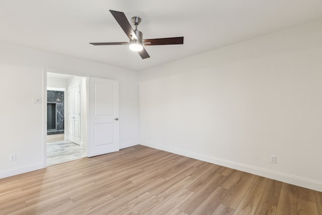 7525 Holly Hill Dr Unit 17, Dallas, TX 75231 - unfurnished bedroom with light wood-type flooring, baseboards, connected bathroom, and a ceiling fan