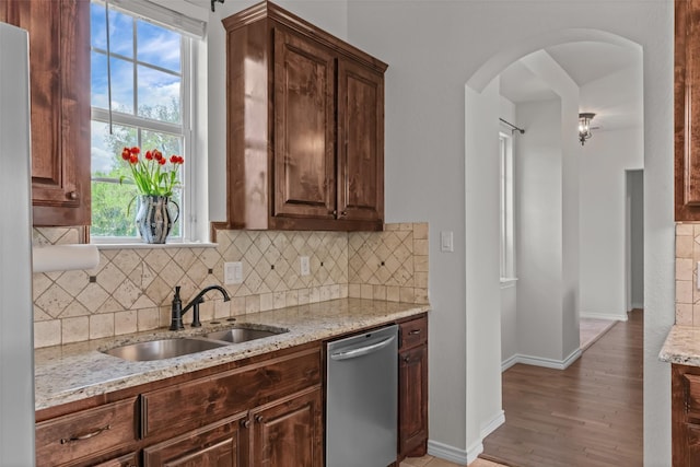240 Stone Mountain Rd, Cresson, TX 76035 - kitchen featuring stainless steel dishwasher, a sink, arched walkways, and light stone countertops