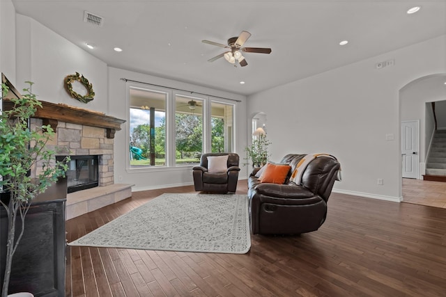 240 Stone Mountain Rd, Cresson, TX 76035 - living area featuring arched walkways, stairs, a stone fireplace, ceiling fan, and baseboards