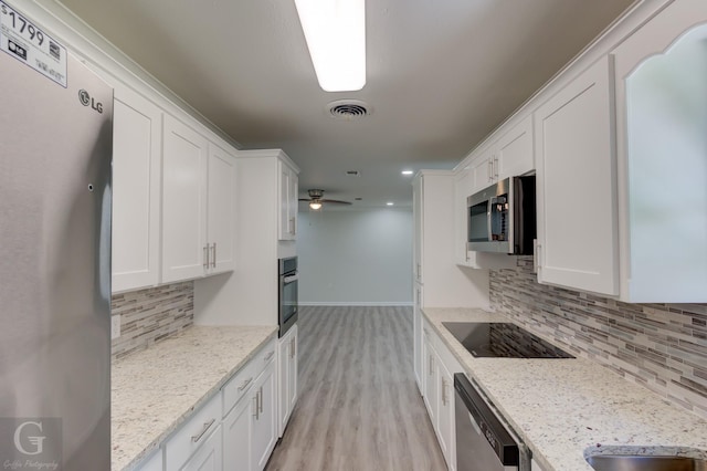 kitchen with stainless steel appliances, baseboards, white cabinets, and recessed lighting