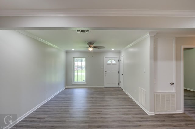 entryway featuring wood finished floors, a ceiling fan, baseboards, and crown molding