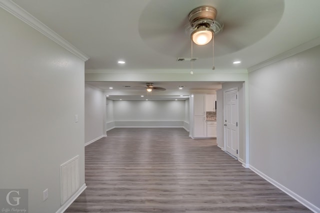 spare room with ceiling fan, crown molding, dark wood-type flooring, baseboards, and recessed lighting
