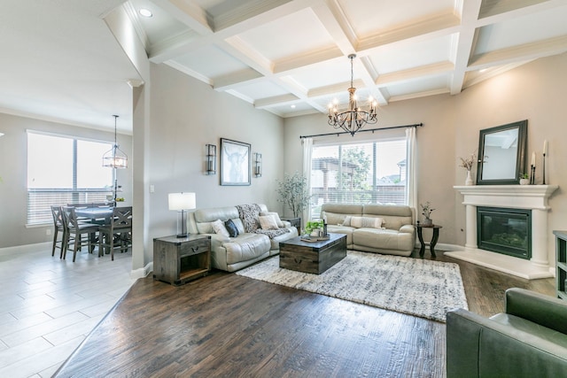 1061 Circle J Trl, Prosper, TX 75078 - living area with a chandelier, baseboards, beam ceiling, a glass covered fireplace, and dark wood-style floors