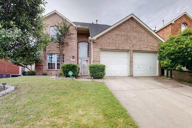 1942 Garrison Way, Garland, TX 75040 - traditional-style home featuring a garage, brick siding, a front yard, and driveway
