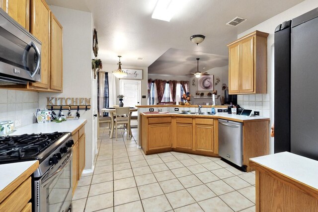 1942 Garrison Way, Garland, TX 75040 - kitchen featuring stainless steel appliances, a sink, decorative backsplash, light countertops, and light tile patterned floors