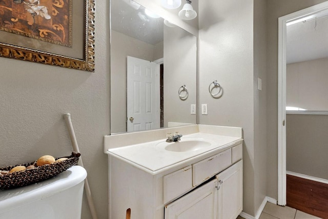1942 Garrison Way, Garland, TX 75040 - half bath with vanity, toilet, tile patterned flooring, and baseboards